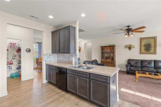 kitchen featuring backsplash, ceiling fan, sink, black dishwasher, and light hardwood / wood-style floors