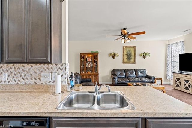 kitchen featuring dishwasher, sink, ceiling fan, tasteful backsplash, and dark brown cabinets