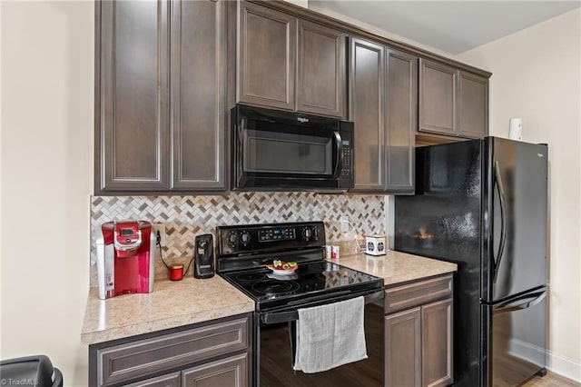 kitchen featuring black appliances, dark brown cabinetry, and tasteful backsplash