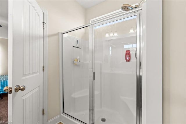 bathroom featuring a shower with door