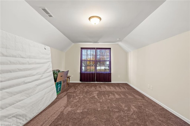 bonus room featuring dark carpet and vaulted ceiling