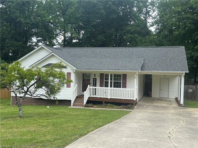 view of front of property featuring driveway, covered porch, a front lawn, roof with shingles, and a carport