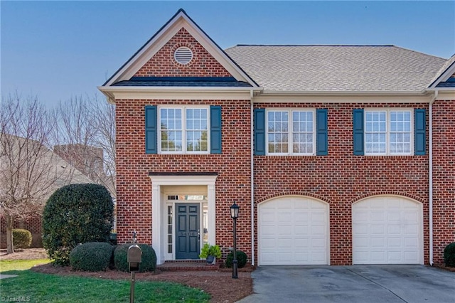 view of front of property featuring brick siding, driveway, an attached garage, and roof with shingles