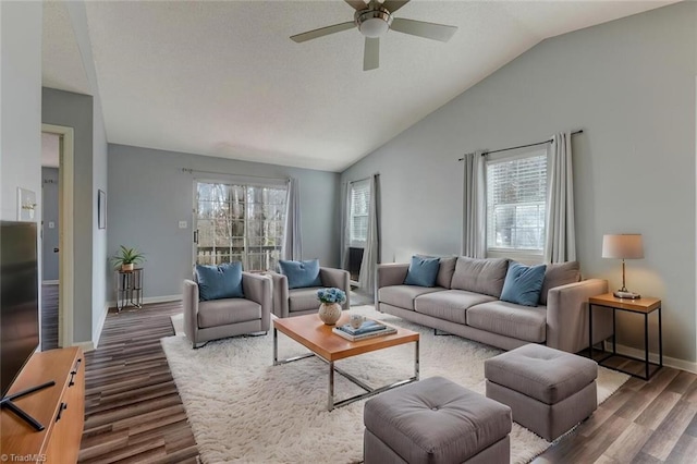 living room with dark hardwood / wood-style flooring, vaulted ceiling, and ceiling fan