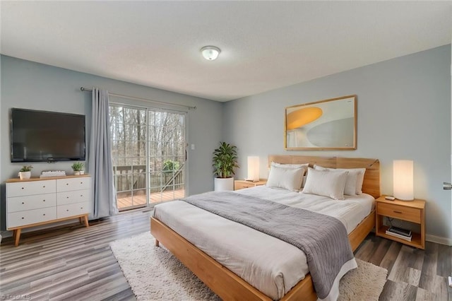 bedroom featuring hardwood / wood-style flooring and access to exterior