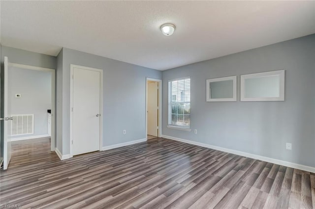 unfurnished bedroom with hardwood / wood-style floors and a closet