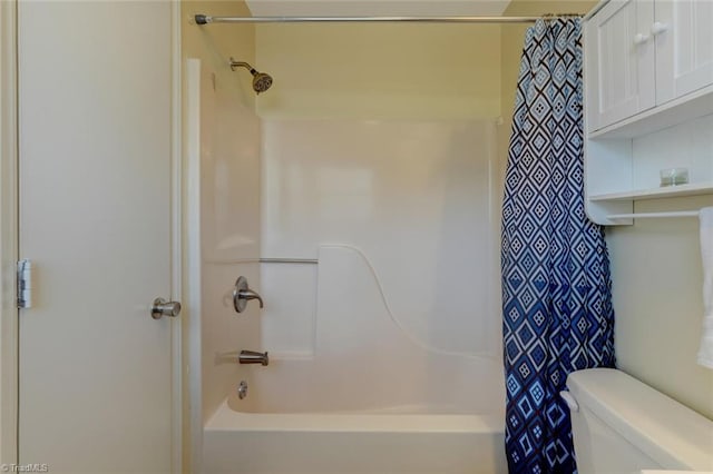 bathroom with toilet and shower / tub combo with curtain