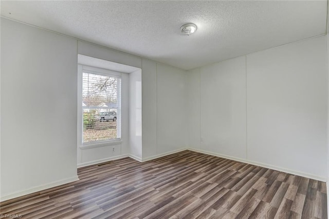 spare room with hardwood / wood-style floors and a textured ceiling