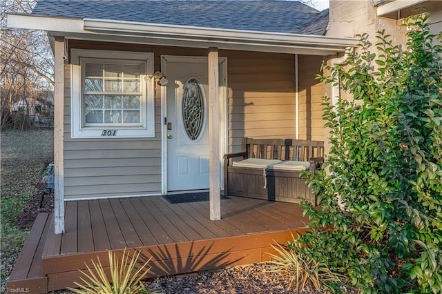 view of exterior entry with a deck