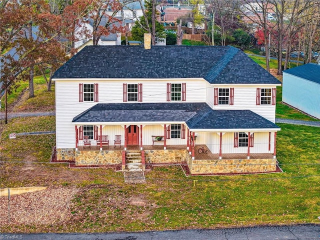 view of front facade featuring a front lawn and covered porch