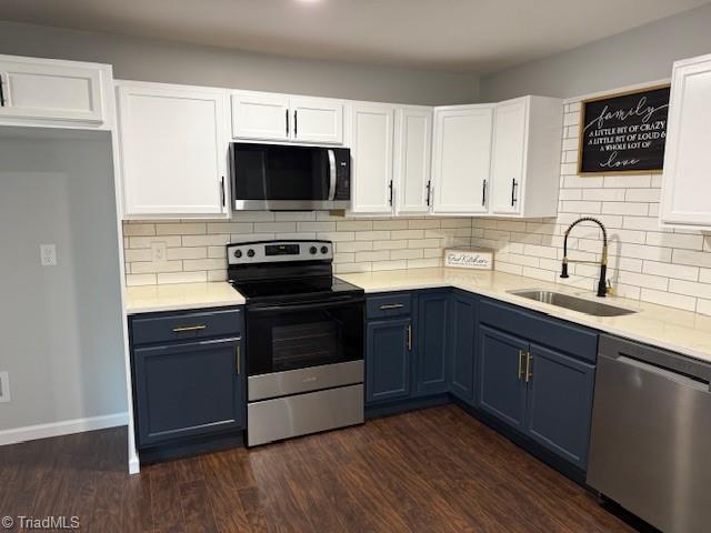 kitchen with white cabinetry, sink, stainless steel appliances, dark hardwood / wood-style floors, and blue cabinets