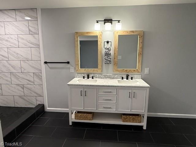 bathroom featuring tile patterned flooring, vanity, and walk in shower