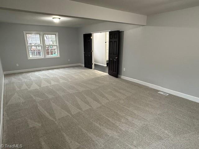 empty room featuring light colored carpet