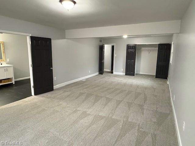 unfurnished bedroom featuring carpet floors and a closet