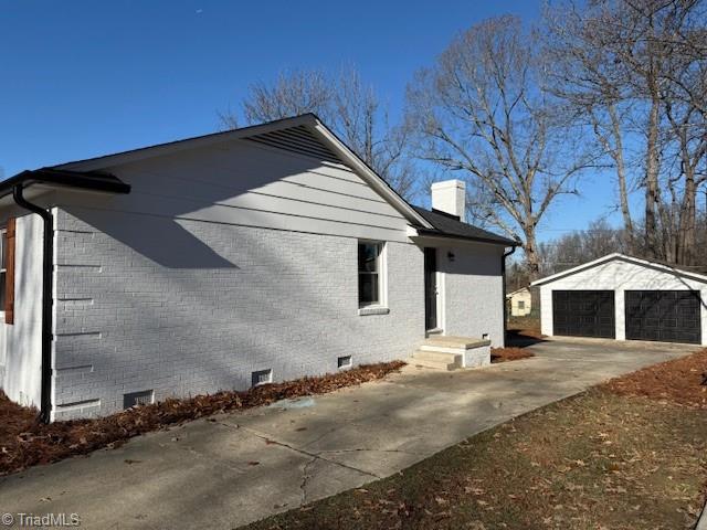 view of property exterior featuring an outbuilding and a garage