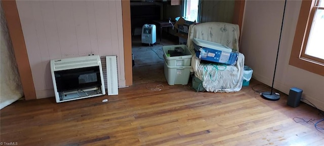 room details with heating unit and hardwood / wood-style flooring