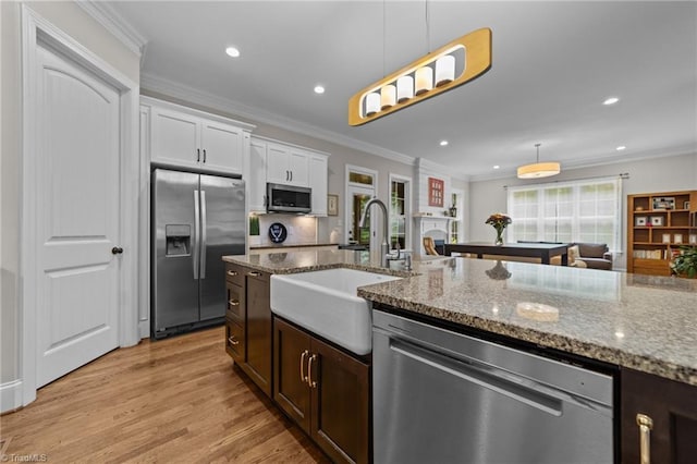 8441 Alice Player Dr, Oak Ridge, NC 27310 - kitchen featuring appliances with stainless steel finishes, a sink, hanging light fixtures, stone countertops, and recessed lighting