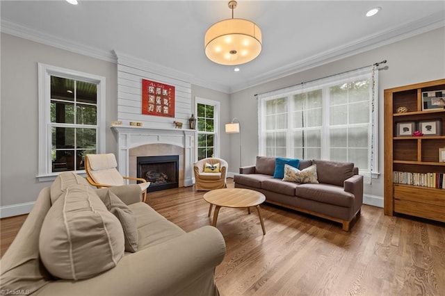 8441 Alice Player Dr, Oak Ridge, NC 27310 - living room featuring a fireplace, wood finished floors, baseboards, ornamental molding, and recessed lighting