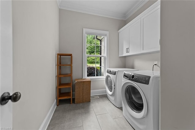 8441 Alice Player Dr, Oak Ridge, NC 27310 - laundry room with separate washer and dryer, cabinet space, crown molding, baseboards, and light tile patterned floors
