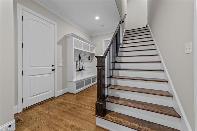 8441 Alice Player Dr, Oak Ridge, NC 27310 - stairway featuring wood finished floors, crown molding, recessed lighting, and baseboards