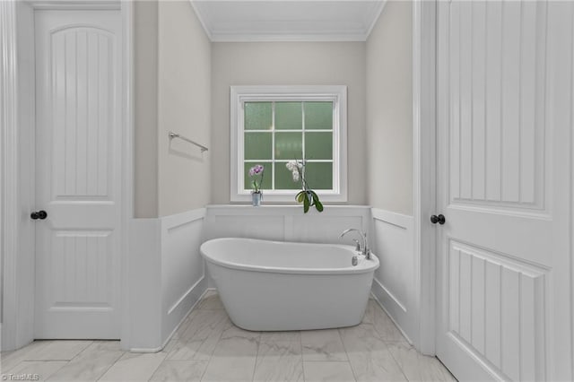8441 Alice Player Dr, Oak Ridge, NC 27310 - full bathroom with marble finish floors, a freestanding tub, ornamental molding, and a wainscoted wall