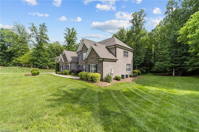 8441 Alice Player Dr, Oak Ridge, NC 27310 - view of home's exterior featuring a yard and stone siding