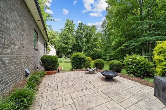 8441 Alice Player Dr, Oak Ridge, NC 27310 - view of patio / terrace featuring an outdoor fire pit