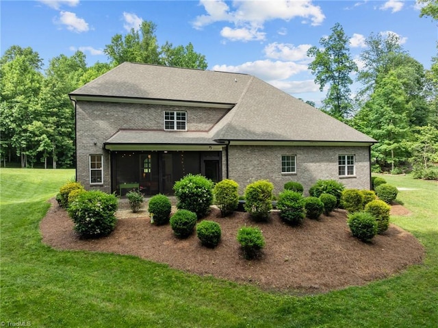 8441 Alice Player Dr, Oak Ridge, NC 27310 - back of house featuring a lawn, a sunroom, roof with shingles, and brick siding