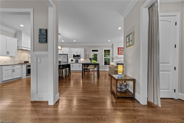 8441 Alice Player Dr, Oak Ridge, NC 27310 - hall with dark wood-style floors, ornamental molding, recessed lighting, and baseboards