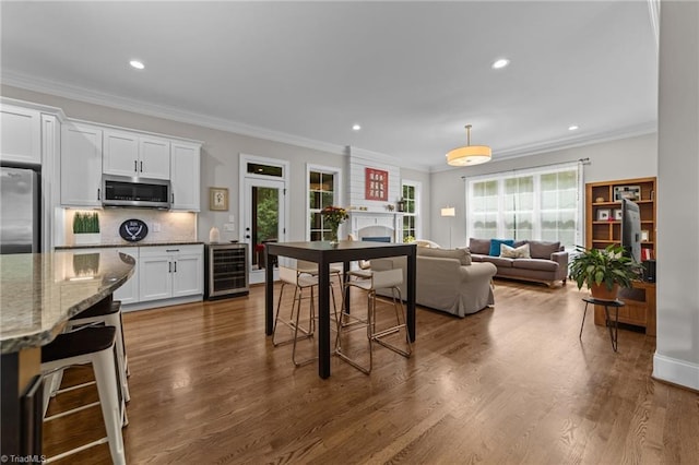 8441 Alice Player Dr, Oak Ridge, NC 27310 - kitchen featuring appliances with stainless steel finishes, wine cooler, plenty of natural light, tasteful backsplash, and recessed lighting