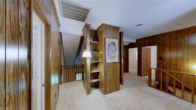 corridor featuring visible vents, carpet, and an upstairs landing