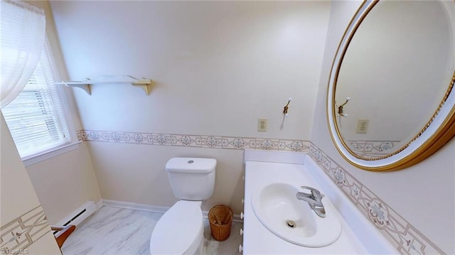 bathroom with a baseboard heating unit, toilet, and vanity