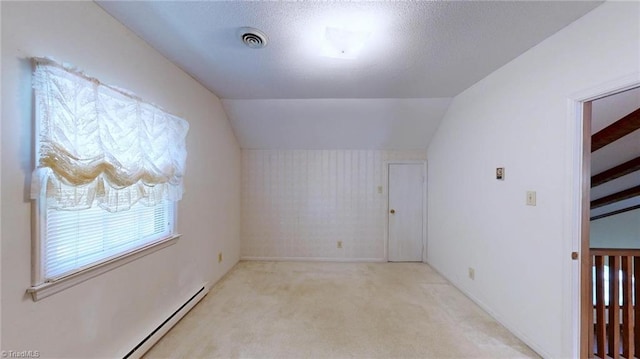 bonus room with a baseboard heating unit, carpet floors, visible vents, and lofted ceiling