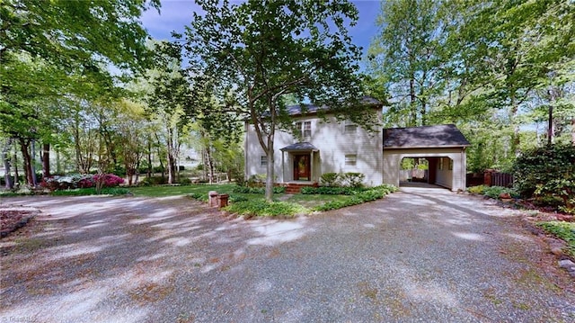 view of front facade featuring fence and dirt driveway