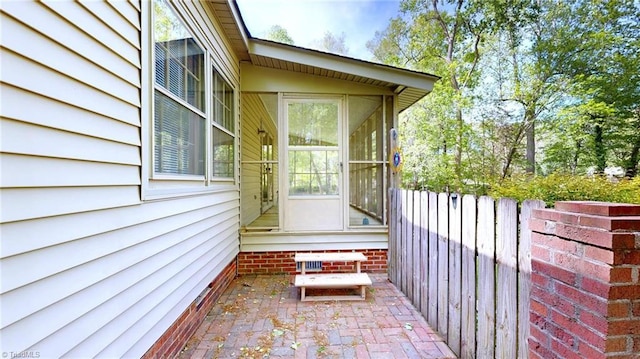 doorway to property with a patio and fence