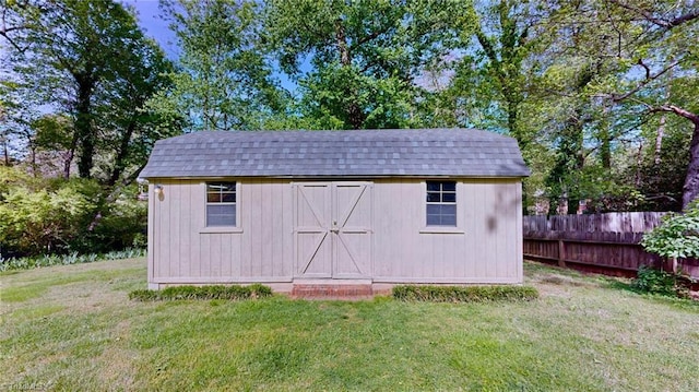 view of shed featuring fence