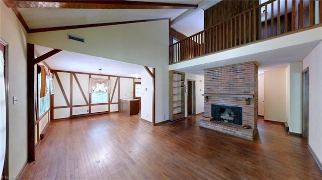 unfurnished living room with baseboards, wood finished floors, high vaulted ceiling, and a notable chandelier