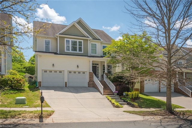 craftsman-style home featuring board and batten siding, an attached garage, driveway, and brick siding