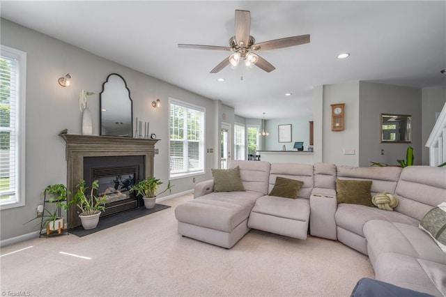 living room with baseboards, a fireplace with flush hearth, carpet flooring, ceiling fan, and recessed lighting