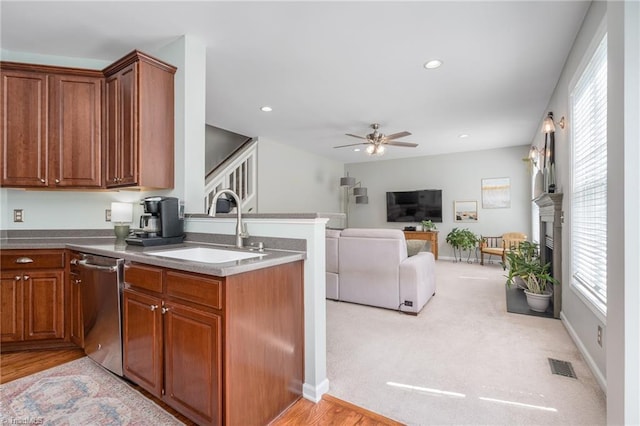 kitchen featuring a sink, dishwasher, a ceiling fan, brown cabinetry, and recessed lighting