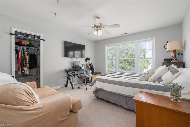 carpeted bedroom featuring baseboards, a closet, and ceiling fan