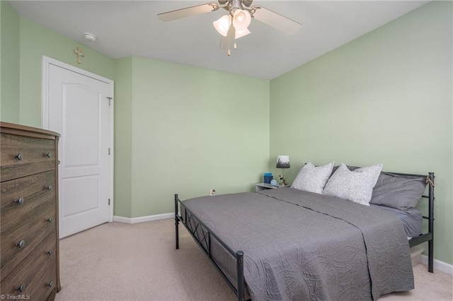 bedroom with carpet flooring, baseboards, and a ceiling fan