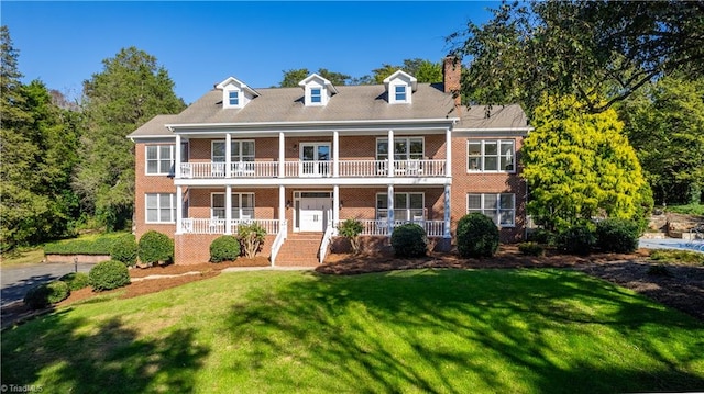 view of front of property with a porch, a front lawn, and a balcony