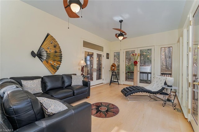 living room with french doors, light hardwood / wood-style floors, and ceiling fan