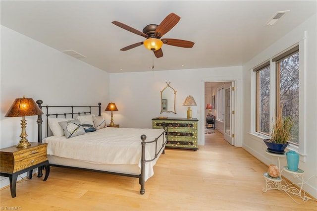 bedroom with light wood-type flooring and ceiling fan