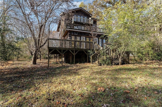 rear view of property featuring a wooden deck