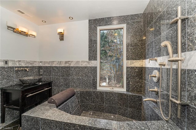 bathroom with sink and tile walls