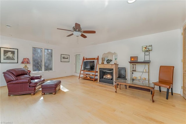 living room with ceiling fan and hardwood / wood-style flooring