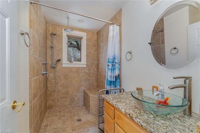 bathroom featuring vanity, tile patterned floors, and walk in shower