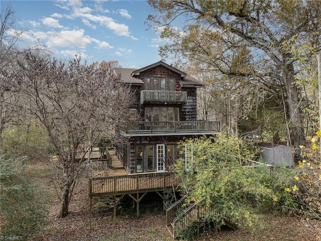 back of property with a balcony and a deck